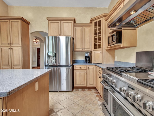 19506 N 73rd Ave, Glendale, AZ 85308 - kitchen with appliances with stainless steel finishes, custom range hood, arched walkways, glass insert cabinets, and light tile patterned floors
