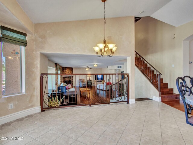 19506 N 73rd Ave, Glendale, AZ 85308 - foyer entrance featuring tile patterned floors, a chandelier, ceiling fan, baseboards, and vaulted ceiling