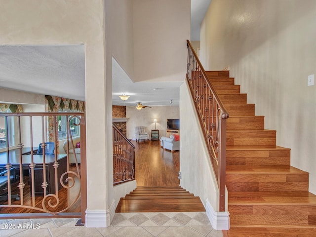 19506 N 73rd Ave, Glendale, AZ 85308 - staircase with tile patterned flooring, ceiling fan, and baseboards