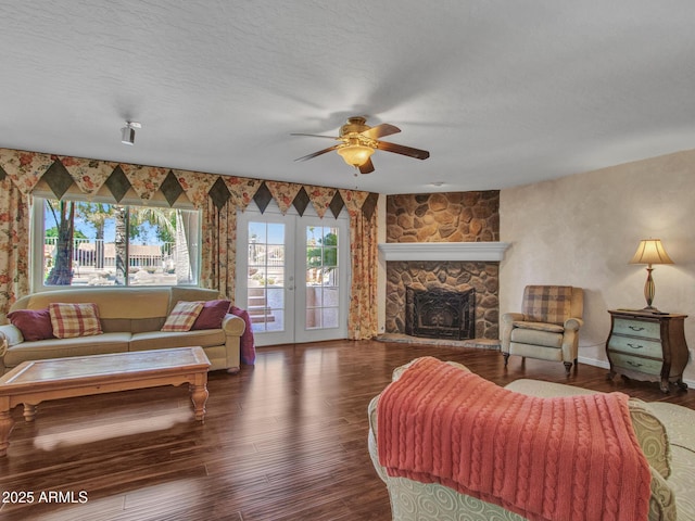 19506 N 73rd Ave, Glendale, AZ 85308 - living room featuring ceiling fan, wood finished floors, french doors, a fireplace, and a textured ceiling