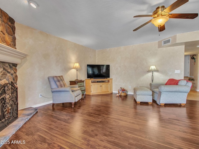 19506 N 73rd Ave, Glendale, AZ 85308 - living room with ceiling fan, wood finished floors, and a stone fireplace