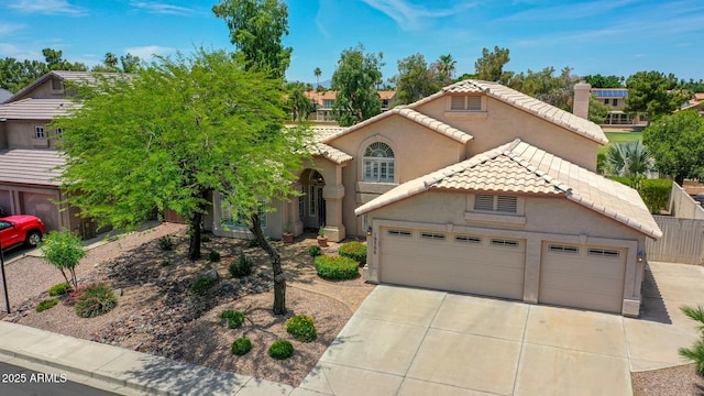 19506 N 73rd Ave, Glendale, AZ 85308 - view of front facade with a tiled roof, concrete driveway, stucco siding, and an attached garage