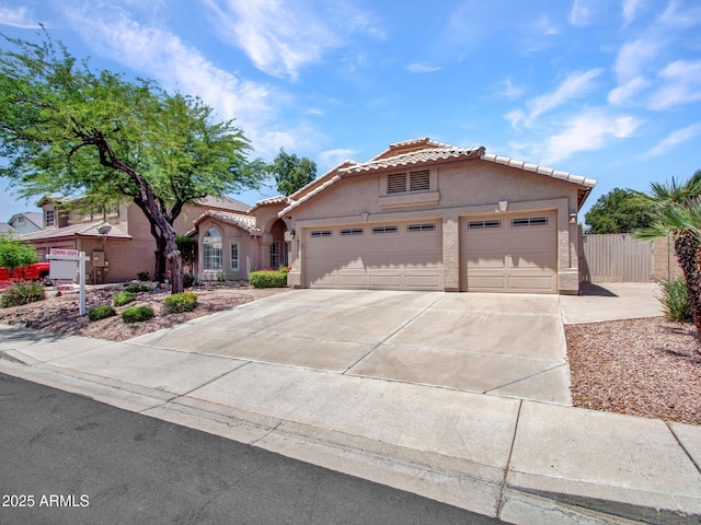 19506 N 73rd Ave, Glendale, AZ 85308 - mediterranean / spanish home with stucco siding, a tiled roof, concrete driveway, and an attached garage