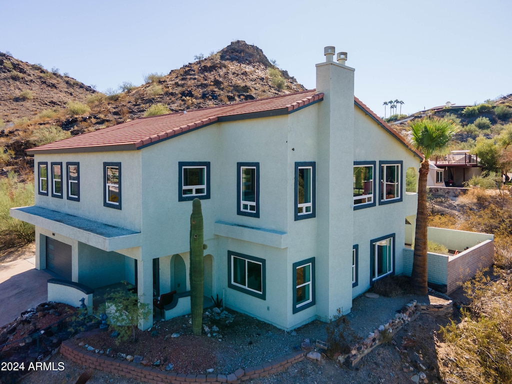 view of side of home with a mountain view