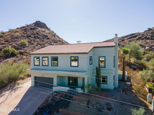 view of front of property featuring a mountain view and a garage