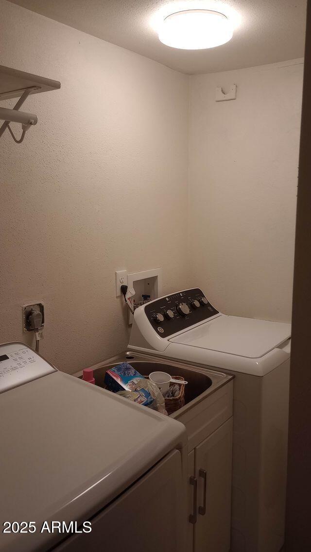 735 E 3rd St, Douglas, AZ 85608 - washroom featuring separate washer and dryer and cabinet space