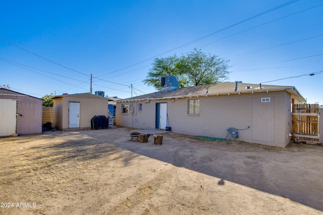 back of property featuring a shed