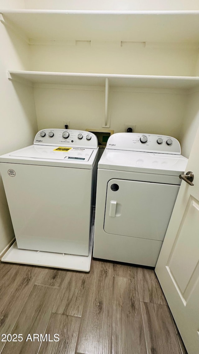 laundry room featuring laundry area, washer and clothes dryer, and light wood-style floors