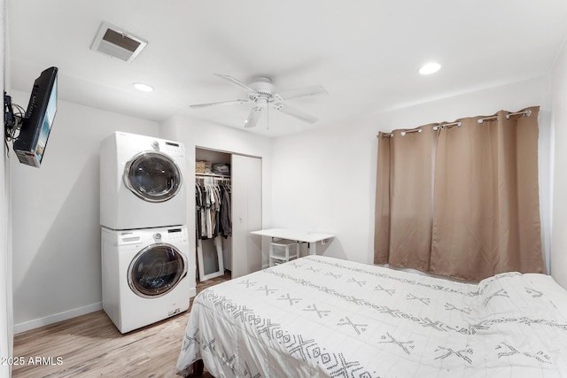 3508 E Gelding Dr, Phoenix, AZ 85032 - bedroom featuring stacked washer / drying machine, light wood-style floors, a closet, baseboards, and recessed lighting