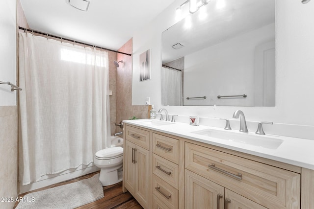 3508 E Gelding Dr, Phoenix, AZ 85032 - full bathroom featuring double vanity, toilet, shower / bath combo with shower curtain, and wood finished floors