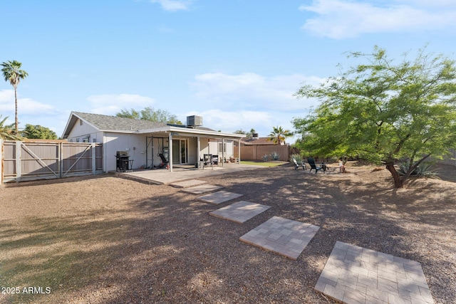 3508 E Gelding Dr, Phoenix, AZ 85032 - back of property with a patio area, a fire pit, a gate, and a fenced backyard