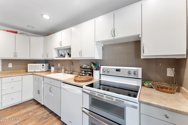 3508 E Gelding Dr, Phoenix, AZ 85032 - kitchen featuring white appliances, a sink, light countertops, backsplash, and recessed lighting
