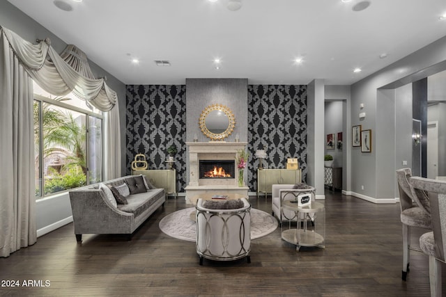 sitting room with a premium fireplace and dark hardwood / wood-style floors