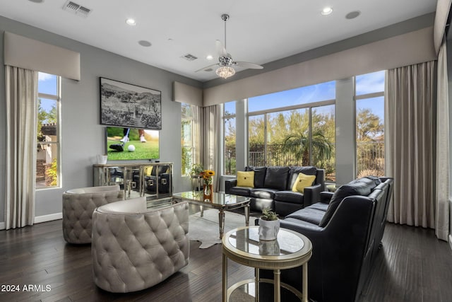 living room with dark wood-type flooring and ceiling fan