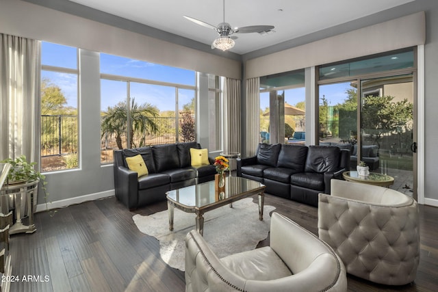 living room with a healthy amount of sunlight, dark hardwood / wood-style floors, and ceiling fan