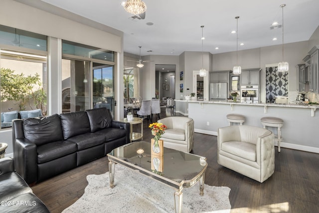 living room featuring dark hardwood / wood-style flooring, ceiling fan, and plenty of natural light