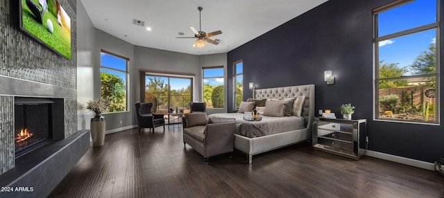 bedroom with dark hardwood / wood-style flooring, ceiling fan, and a high ceiling