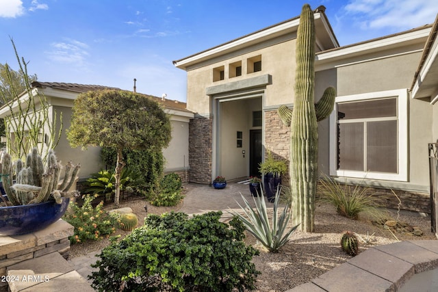 property entrance featuring a patio area