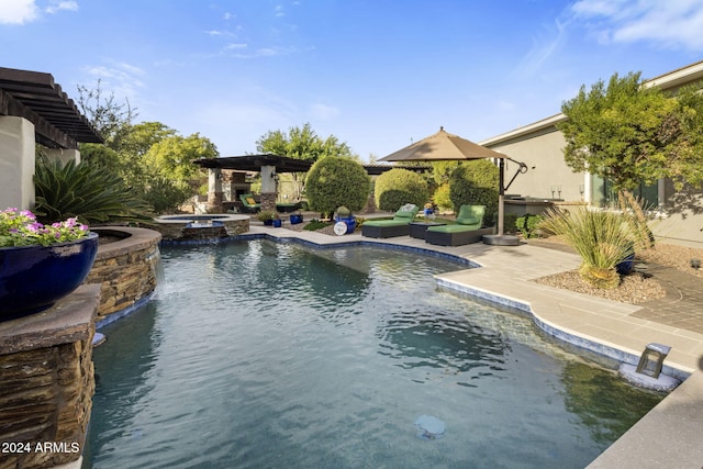 view of pool featuring a patio area and an in ground hot tub