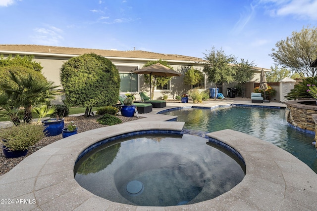 view of swimming pool featuring a patio and an in ground hot tub