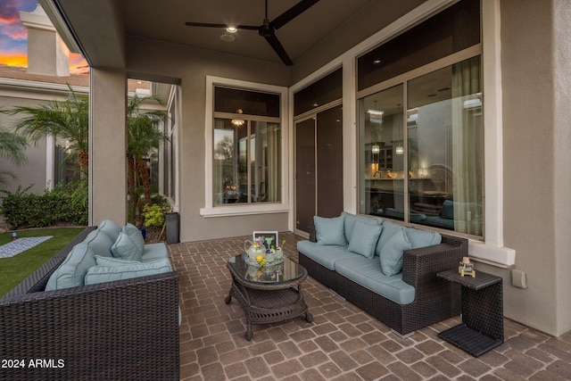 patio terrace at dusk with ceiling fan and an outdoor hangout area