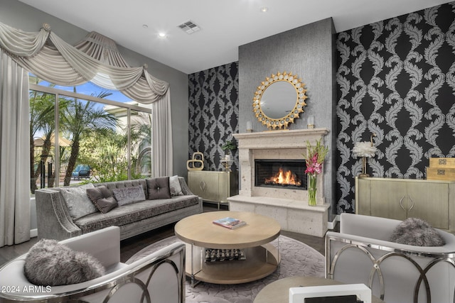 living room with hardwood / wood-style flooring and a high end fireplace