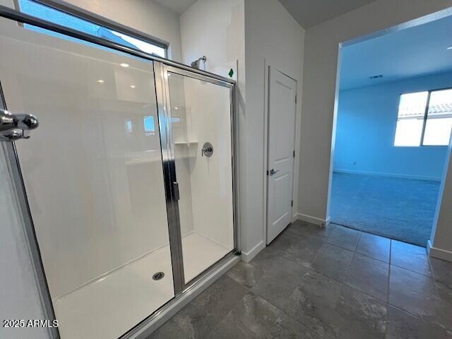 bathroom featuring a shower with shower door