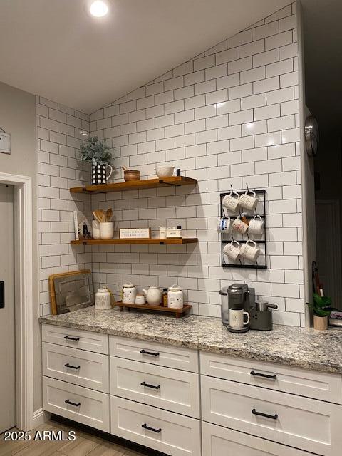18132 E Vencino St, Gilbert, AZ 85298 - bar with lofted ceiling, decorative backsplash, and wood finished floors