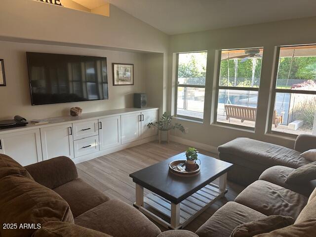 18132 E Vencino St, Gilbert, AZ 85298 - living room featuring light wood finished floors, vaulted ceiling, and baseboards