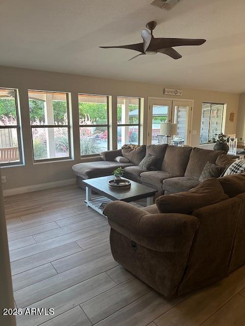 18132 E Vencino St, Gilbert, AZ 85298 - living area with a ceiling fan, baseboards, and light wood-style flooring