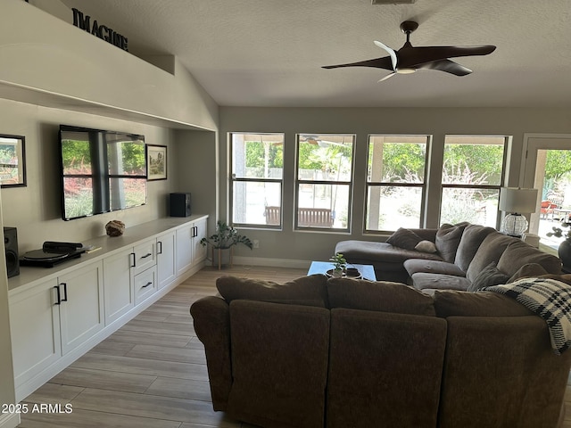 18132 E Vencino St, Gilbert, AZ 85298 - living area featuring ceiling fan, light wood-style floors, a textured ceiling, lofted ceiling, and baseboards