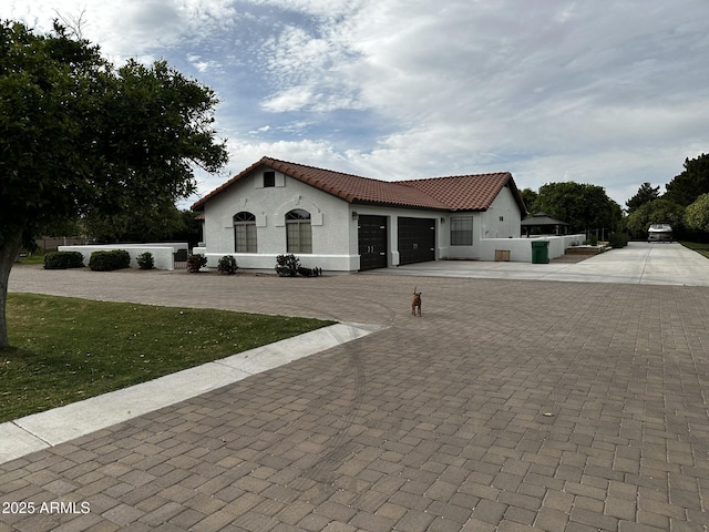 18132 E Vencino St, Gilbert, AZ 85298 - mediterranean / spanish house featuring a tile roof, stucco siding, a garage, and driveway