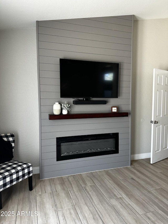 18132 E Vencino St, Gilbert, AZ 85298 - detailed view of a fireplace, wood finished floors, and baseboards