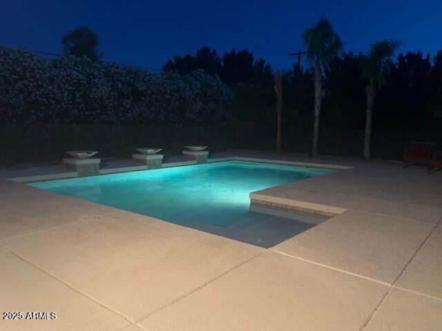 18132 E Vencino St, Gilbert, AZ 85298 - pool at night with a patio area