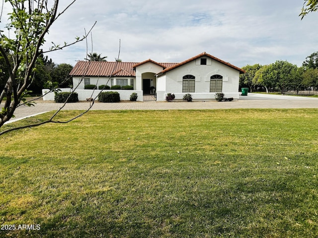 18132 E Vencino St, Gilbert, AZ 85298 - mediterranean / spanish home featuring a tiled roof, stucco siding, and a front yard