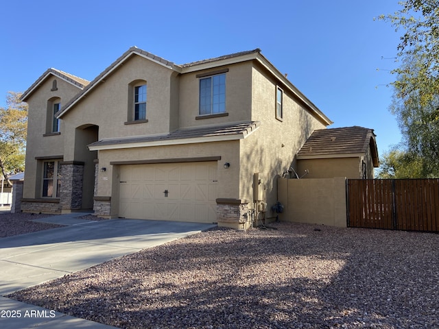 view of front facade with stucco siding, driveway, a garage, and fence