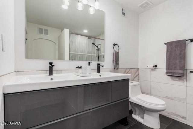 full bathroom with toilet, visible vents, and tile walls