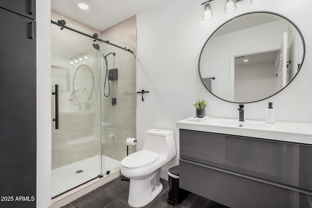 bathroom with visible vents, a stall shower, vanity, and toilet