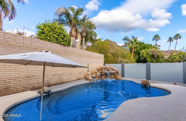 view of swimming pool with a fenced backyard and a fenced in pool