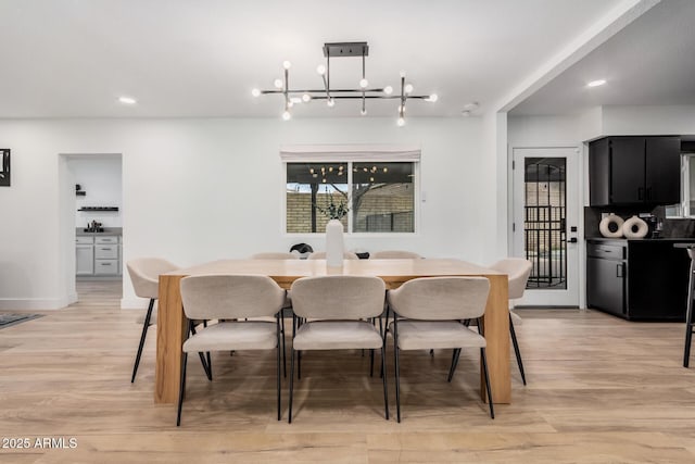 dining room featuring light wood-type flooring and recessed lighting