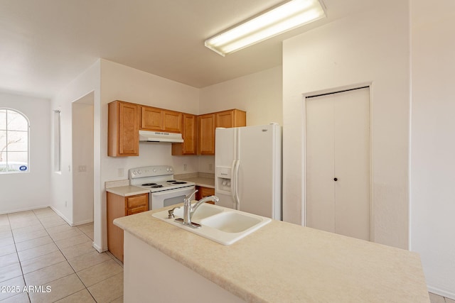 kitchen featuring white appliances, sink, and light tile patterned floors