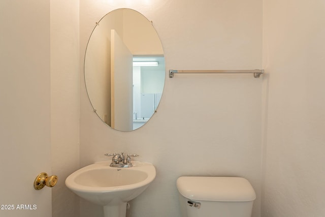 bathroom featuring toilet and sink