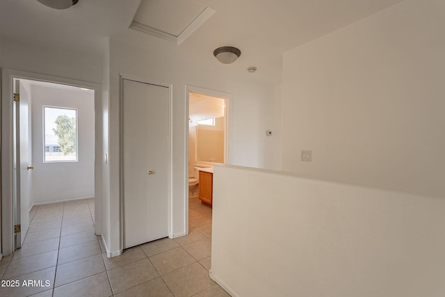 corridor with light tile patterned floors