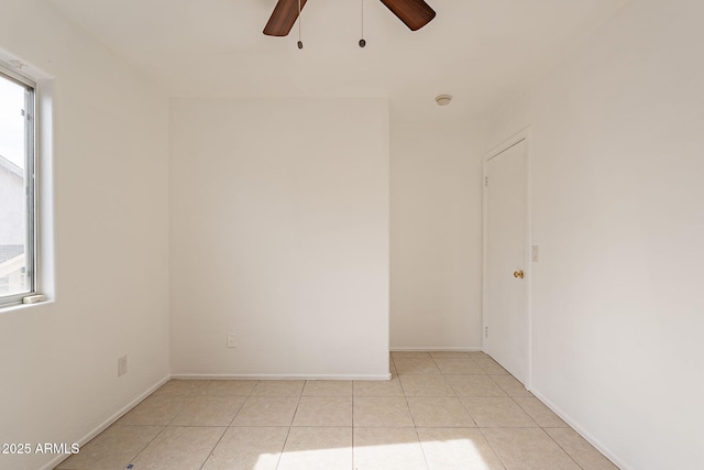 empty room with light tile patterned floors and ceiling fan