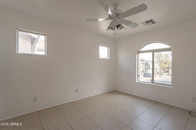 empty room featuring light tile patterned flooring and ceiling fan