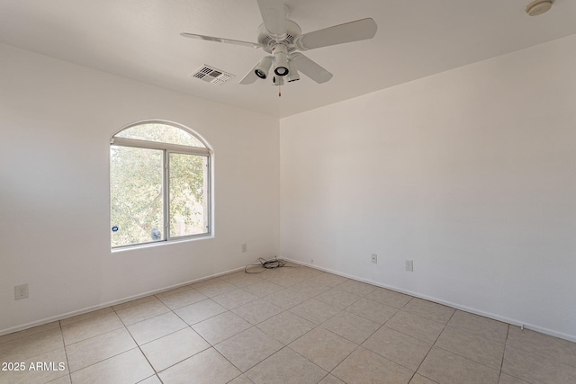 tiled empty room with ceiling fan