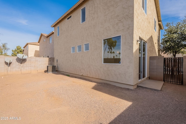 rear view of property with central AC unit