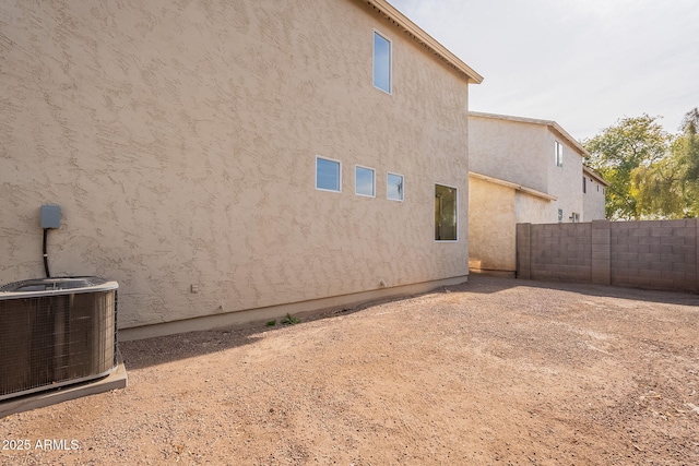 rear view of house featuring central air condition unit