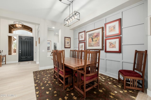 dining room with a chandelier and light hardwood / wood-style floors