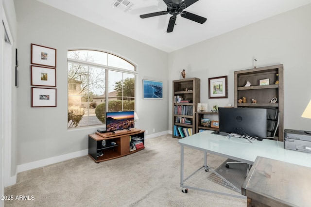 office space with ceiling fan and light carpet